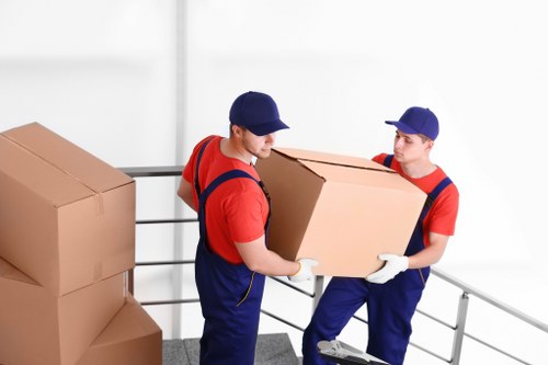 Mover with protective equipment preparing items for a safe removal in Covent Garden