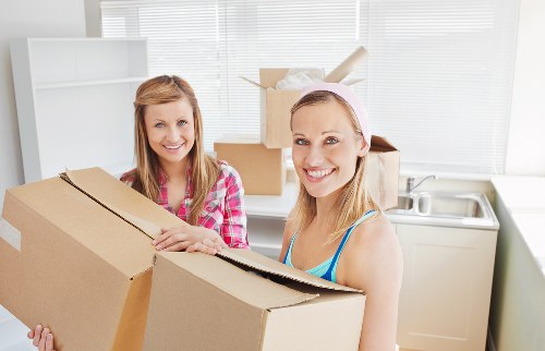 Packed moving boxes and furniture in a central London flat